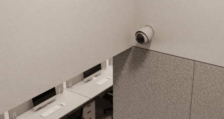 Kleine camera in de hoek van een kantoorplafond boven bureaus